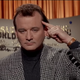 Bill Murray feigns telepathy by holding a finger to his temple in a scene from Ghostbusters II